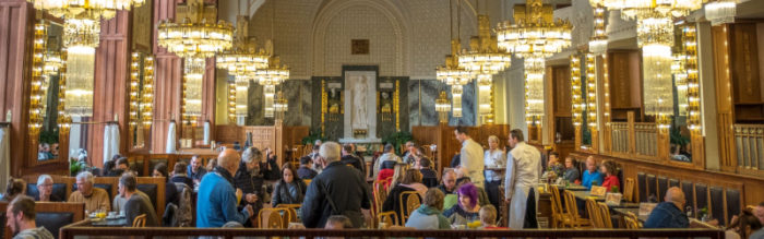 large room in cafe with low hung chandeliers