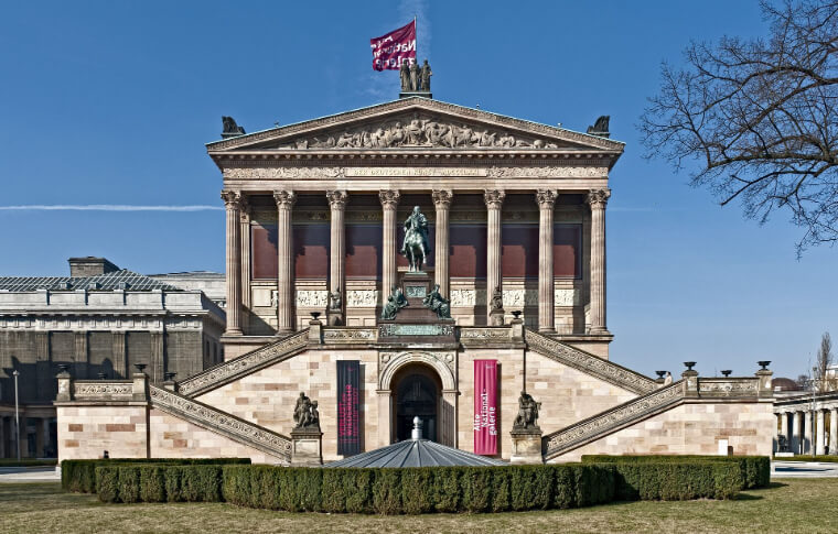 large museum with symmetrical stairs and columns at entrance