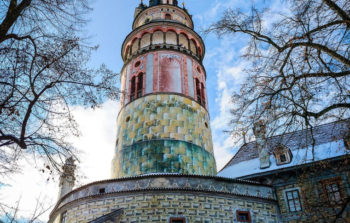 looming cylindrical tower with pinks and greens