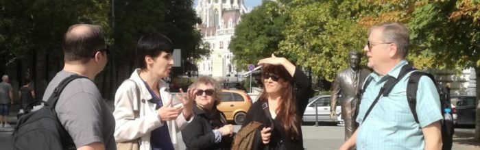 A guide leads a group around Budapest.