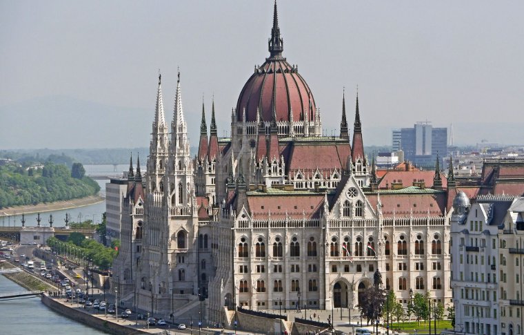 huge parliament house with large dome and white spires