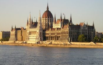 huge parliament house with large dome and white spires