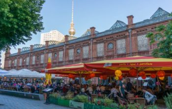 A red brick building behind a market.