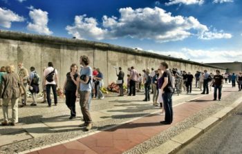 Tourists look at remains of the Berlin Wall.