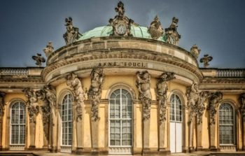 ornate palace with gargoyles and arch windows