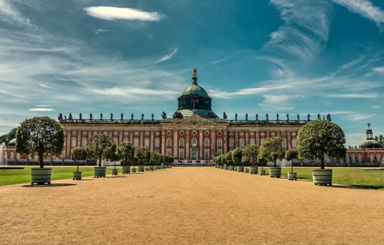 vast palace in red with large green dome in center