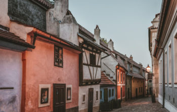 old and small buildings along street in pinks and white