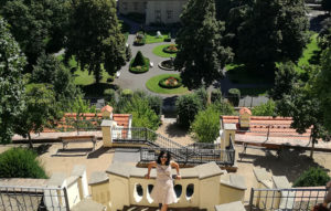 women smiling on top of hill overlooking tiered garden