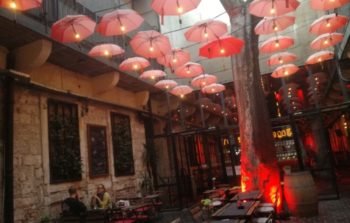 Lights made of umbrellas fill a roof area.