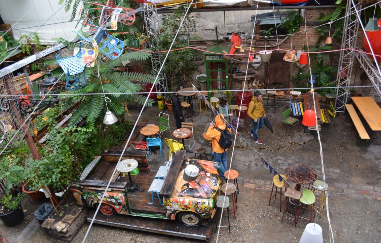 A plant filled and eclectic ruin bar.