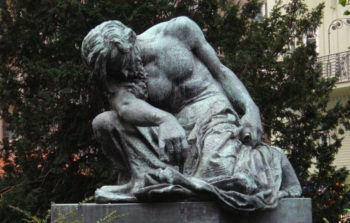 statue of shirtless man looking down