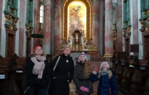 Family on a walking tour in a church in Vienna