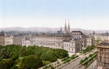 The view of a palace with church spires behind.