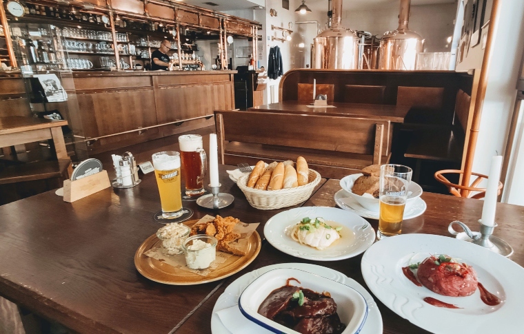 beer and a collection of snacks on a table in a restaurant