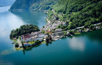 town in the distance next to lake and mountains