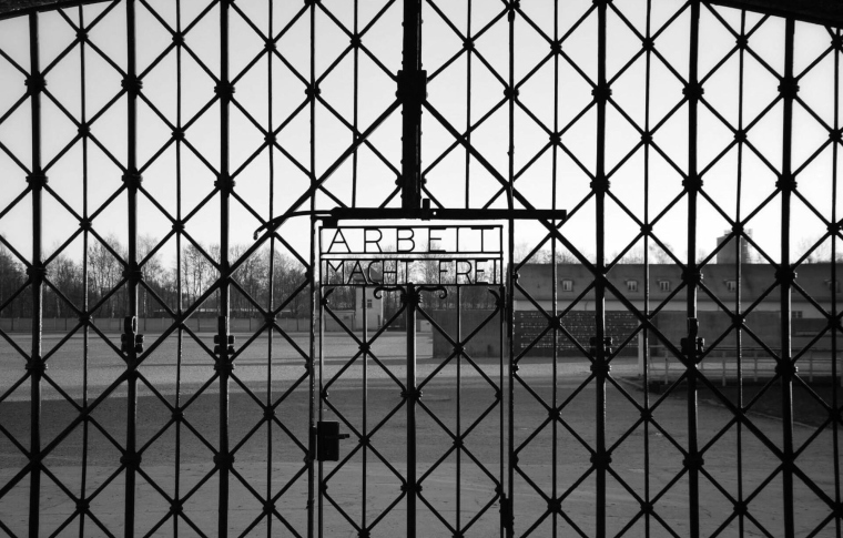 concentration camp's iron fence with the words Arbeit macht frei